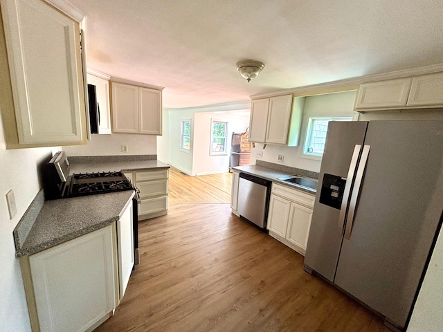 12 Amelia Way S, Yarmouth, MA 02664 - kitchen with appliances with stainless steel finishes, light wood-type flooring, and dark countertops