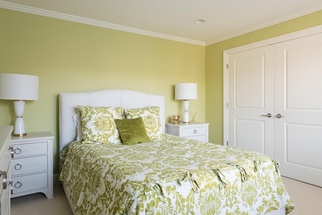 bedroom with a closet, carpet, and ornamental molding