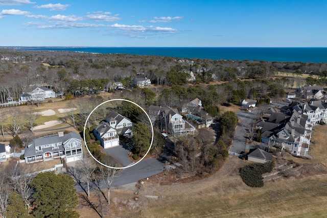 drone / aerial view featuring a water view and a residential view