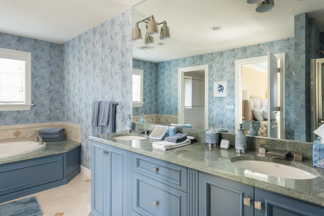 bathroom with wallpapered walls, plenty of natural light, and a sink