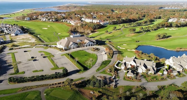 drone / aerial view featuring view of golf course and a water view