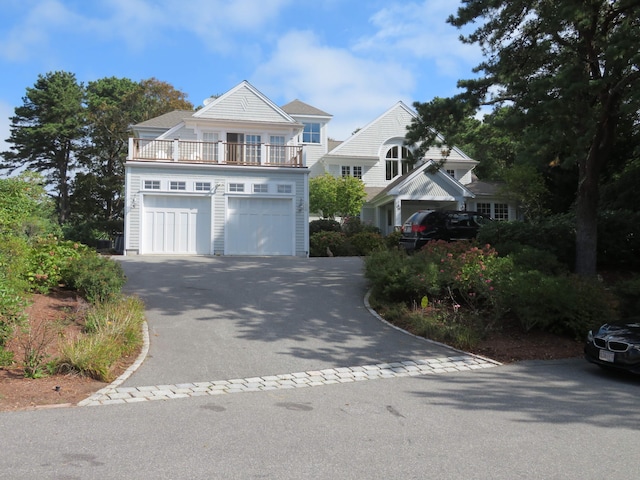 view of front of home featuring a balcony, a garage, and driveway