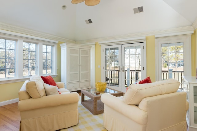 sunroom / solarium with visible vents, lofted ceiling, and a healthy amount of sunlight