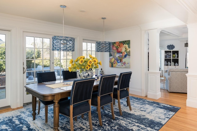 dining space with crown molding and ornate columns