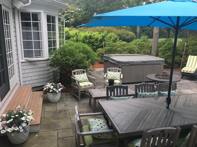 deck featuring a patio, outdoor dining space, and a hot tub