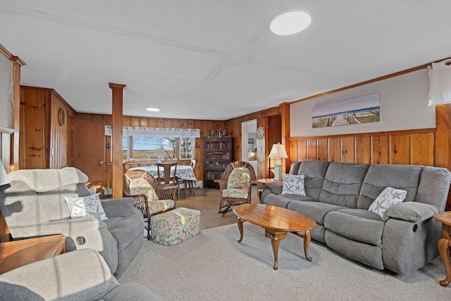 living room featuring crown molding, wooden walls, and carpet