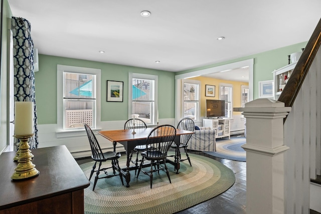 dining space featuring stairs, recessed lighting, and a wainscoted wall