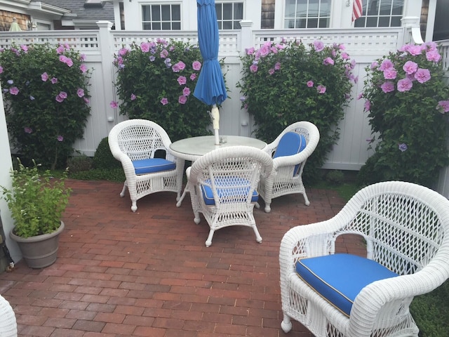 view of patio featuring outdoor dining space and fence