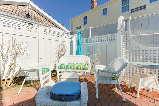 view of patio / terrace featuring outdoor lounge area and fence