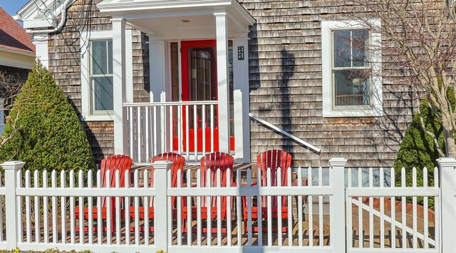 view of exterior entry featuring fence