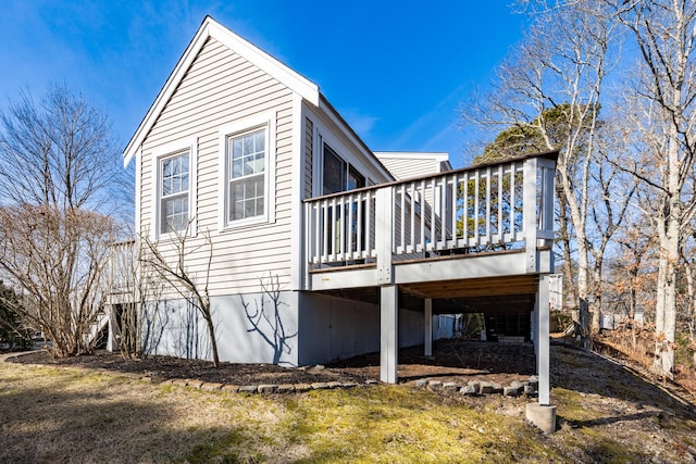 rear view of property with a yard and a deck