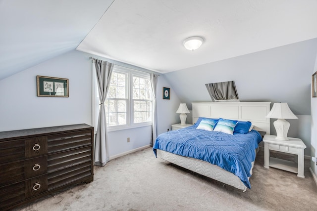 bedroom featuring light carpet, vaulted ceiling, and baseboards