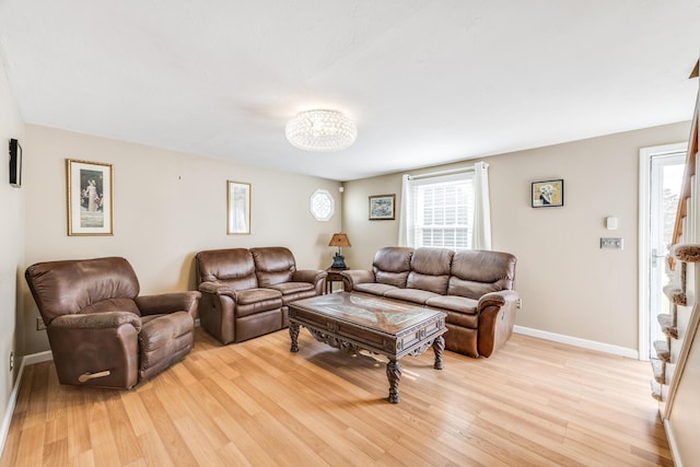 living room with baseboards and light wood-style floors