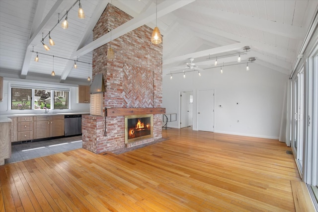174 Waterway, Mashpee, MA 02649 - unfurnished living room featuring light wood finished floors, a fireplace, high vaulted ceiling, a ceiling fan, and a sink