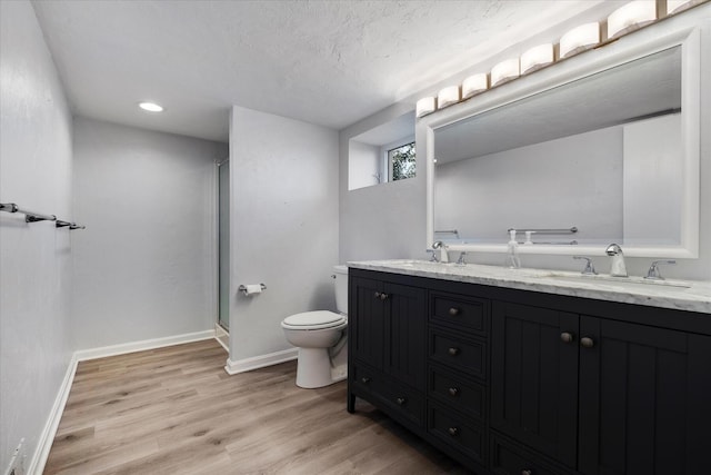 174 Waterway, Mashpee, MA 02649 - bathroom with toilet, double vanity, wood finished floors, a stall shower, and a textured ceiling