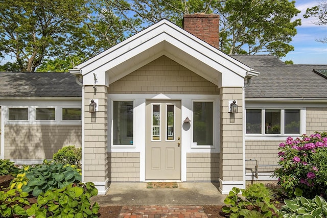 174 Waterway, Mashpee, MA 02649 - property entrance with a chimney and roof with shingles