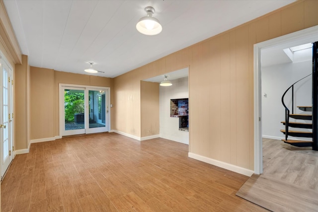 174 Waterway, Mashpee, MA 02649 - spare room featuring stairway, light wood-style floors, baseboards, and a skylight