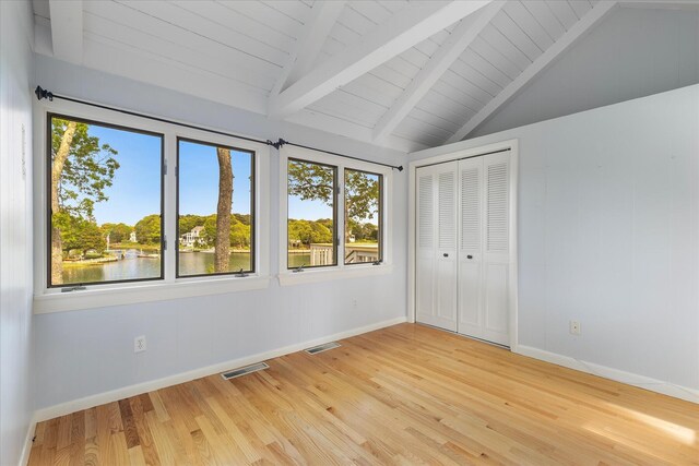 174 Waterway, Mashpee, MA 02649 - unfurnished bedroom with multiple windows, light wood-style flooring, baseboards, and wooden ceiling