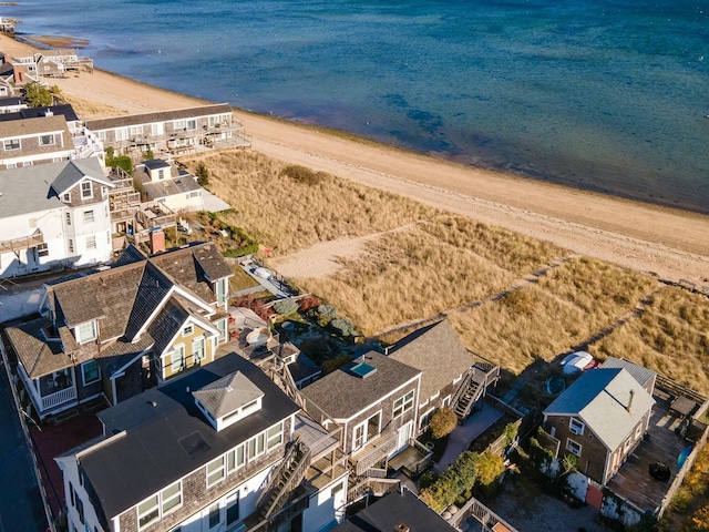 drone / aerial view with a water view and a beach view