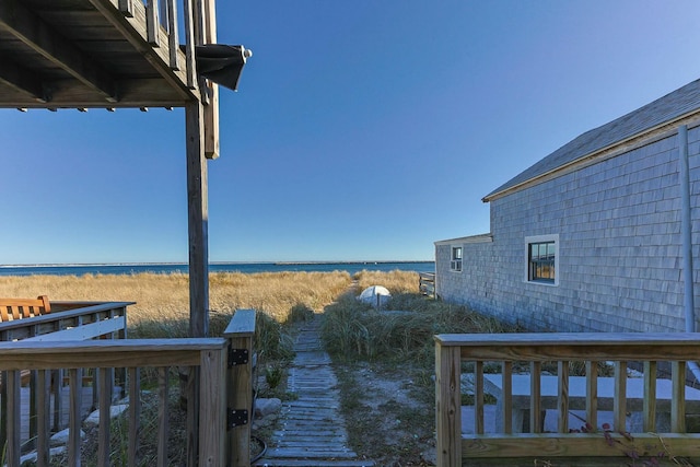 view of yard featuring a deck with water view