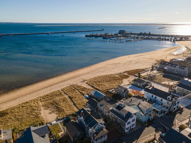 drone / aerial view featuring a water view and a view of the beach