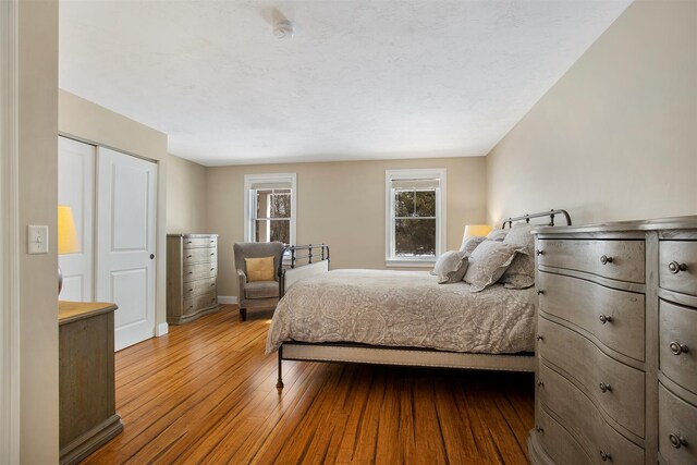 corridor featuring baseboards and dark wood-style flooring