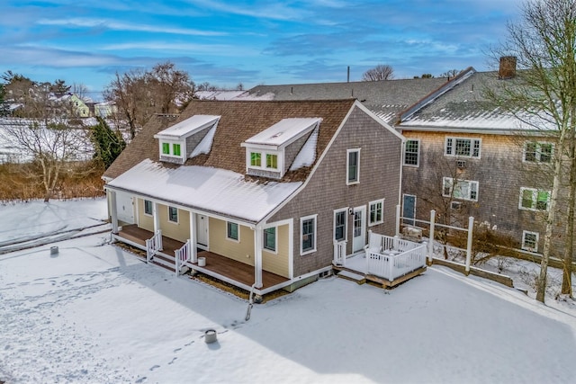 view of snow covered rear of property