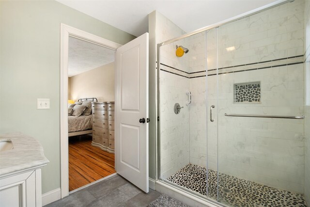 full bathroom featuring a shower stall, vanity, and ensuite bathroom