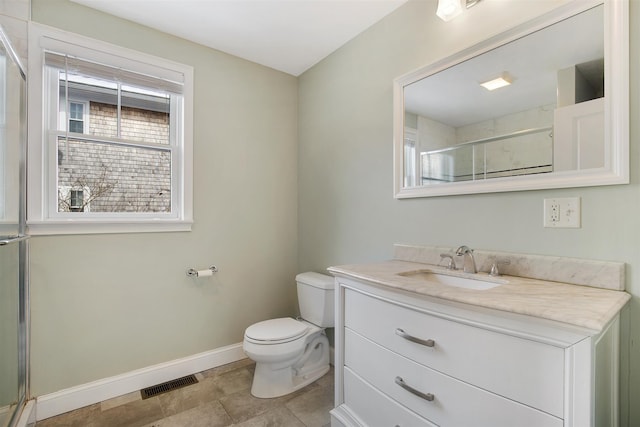 bathroom featuring toilet, vanity, visible vents, baseboards, and a shower stall