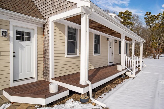 view of front of property with an attached garage, a porch, and roof with shingles