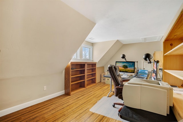 office area with lofted ceiling, light wood-type flooring, and baseboards