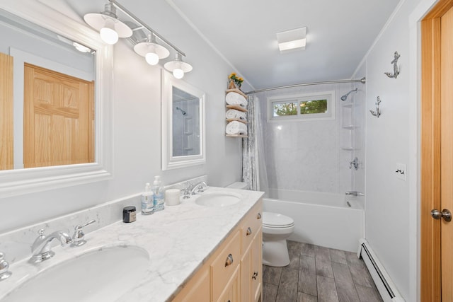 bathroom featuring wood finished floors, a sink, a baseboard heating unit, and toilet