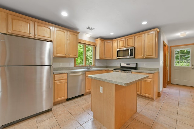 1311 Main St, Cotuit, MA 02635 - kitchen featuring appliances with stainless steel finishes, a sink, light countertops, a kitchen island, and light tile patterned floors
