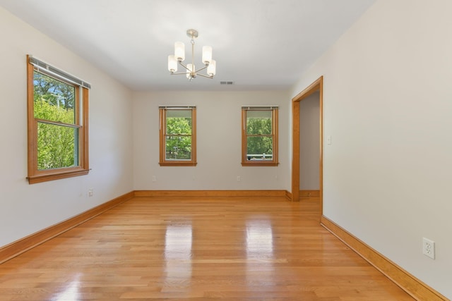 1311 Main St, Cotuit, MA 02635 - unfurnished room with a chandelier, light wood-style flooring, and baseboards
