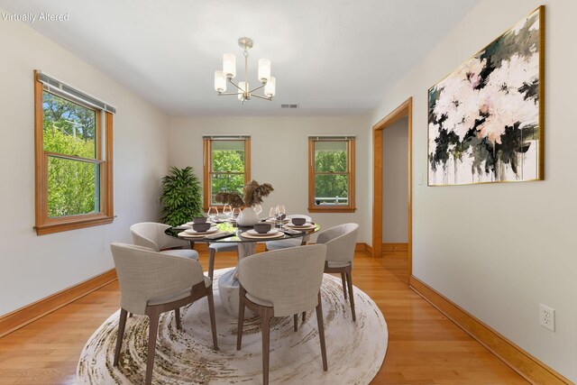 1311 Main St, Cotuit, MA 02635 - dining area with a chandelier and light wood-type flooring