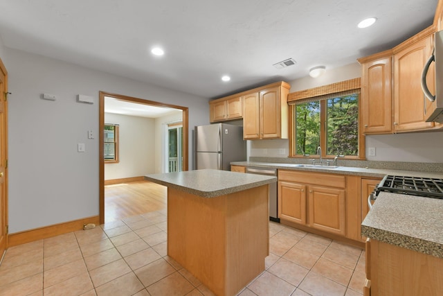 1311 Main St, Cotuit, MA 02635 - kitchen featuring stainless steel appliances, a sink, a kitchen island, light tile patterned floors, and recessed lighting