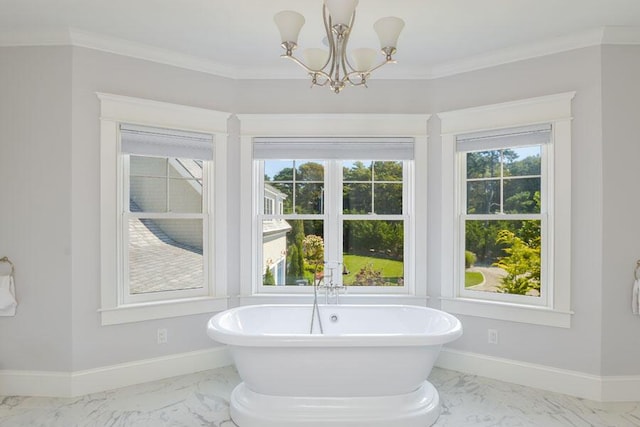 bathroom featuring an inviting chandelier, ornamental molding, a bathing tub, and a healthy amount of sunlight