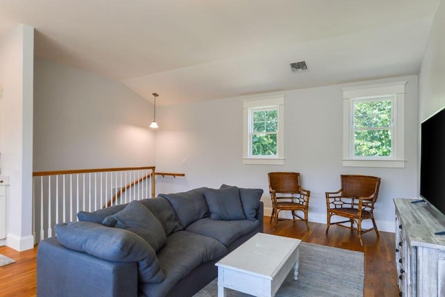 living room with dark hardwood / wood-style floors and lofted ceiling