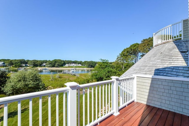 deck featuring a lawn and a water view