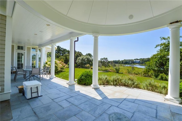 view of patio with a water view