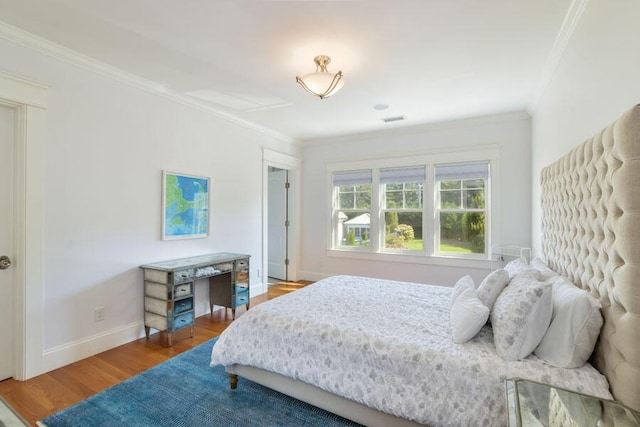 bedroom with crown molding and wood-type flooring