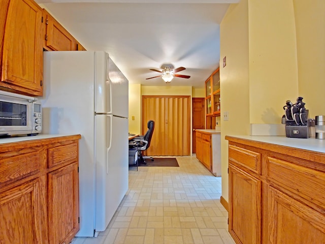 15 Fir St, Wareham, MA 02571 - kitchen featuring freestanding refrigerator, light countertops, an office area, brown cabinetry, and a ceiling fan