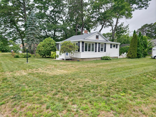 15 Fir St, Wareham, MA 02571 - back of house with a chimney, a yard, and view of scattered trees