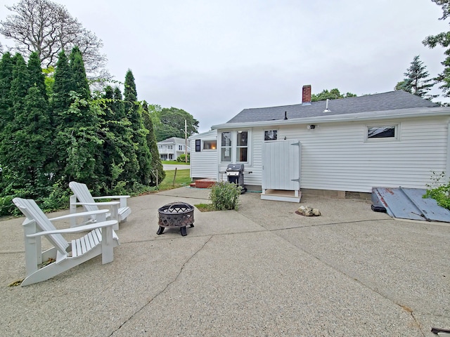 15 Fir St, Wareham, MA 02571 - rear view of house featuring an outdoor fire pit, a patio, and a chimney