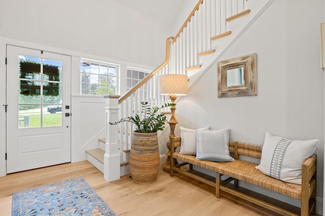 foyer entrance featuring stairway and wood finished floors