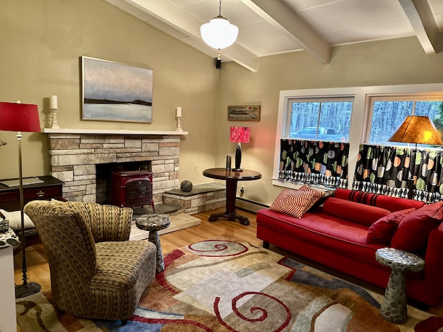 53 Highland Rd, North Truro, MA 02652 - living room with wood finished floors, a wood stove, and a baseboard heating unit