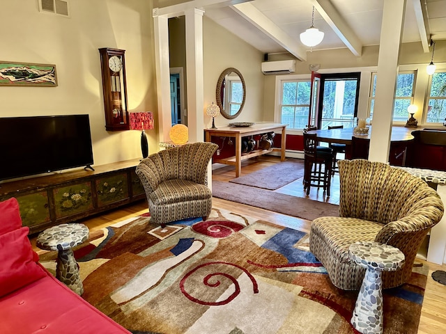 53 Highland Rd, North Truro, MA 02652 - living room with an AC wall unit, wood finished floors, beam ceiling, and a baseboard radiator