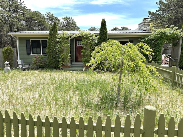 53 Highland Rd, North Truro, MA 02652 - obstructed view of property with fence, metal roof, and a chimney