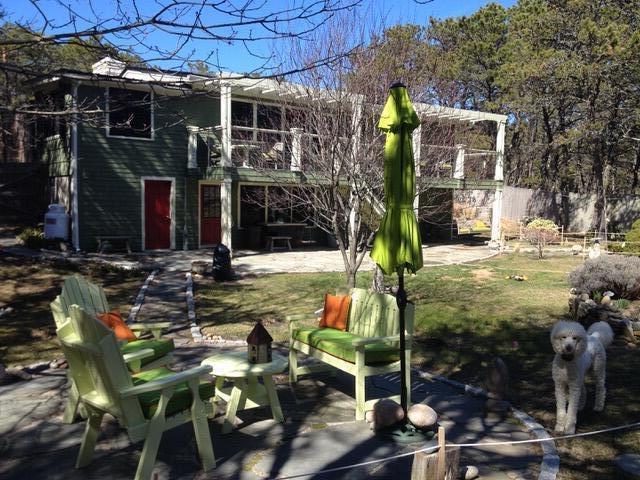 53 Highland Rd, North Truro, MA 02652 - back of property featuring a patio area and fence
