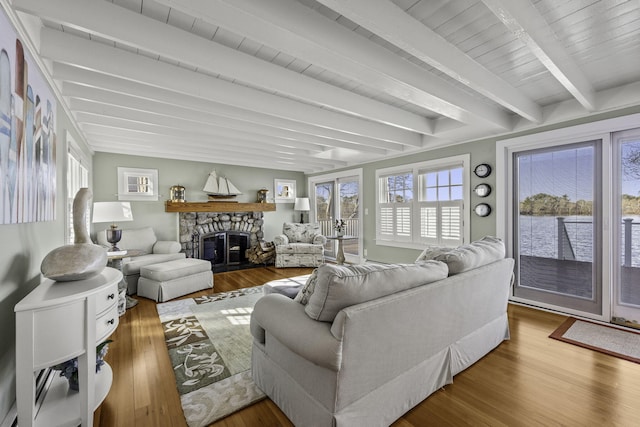 122 Point Of Pines Ave, Centerville, MA 02632 - living area with beamed ceiling, wood finished floors, and a stone fireplace